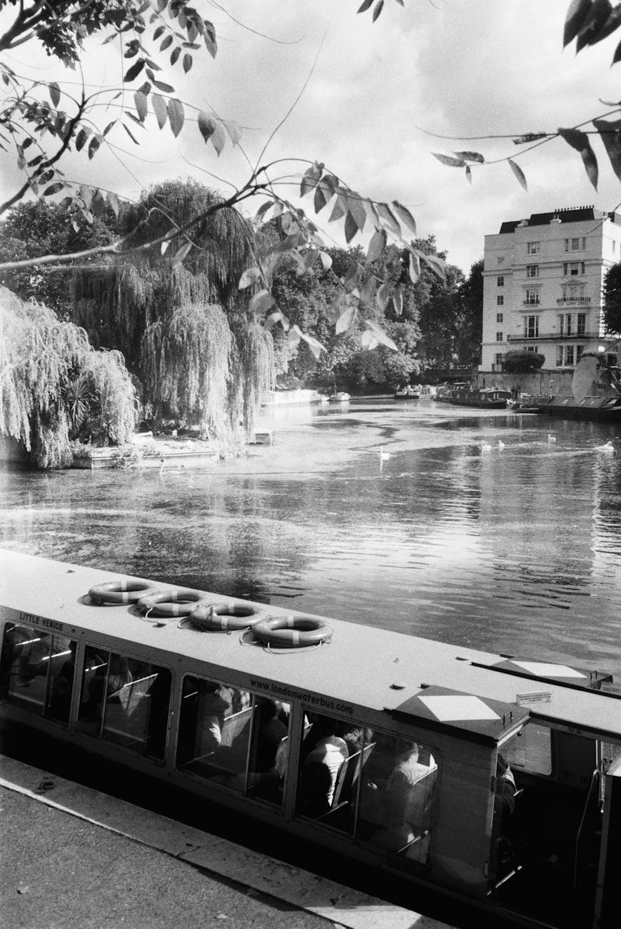 black and white photo of a building by regent s canal in london england
